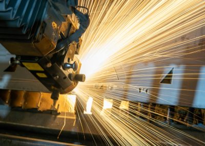 man in blue jacket standing beside brown wooden post